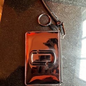 Marc Jacobs wallet. Has ring to be attached to keys. Color is Brown Chrome